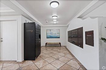 A hallway with a locker and a painting on the wall